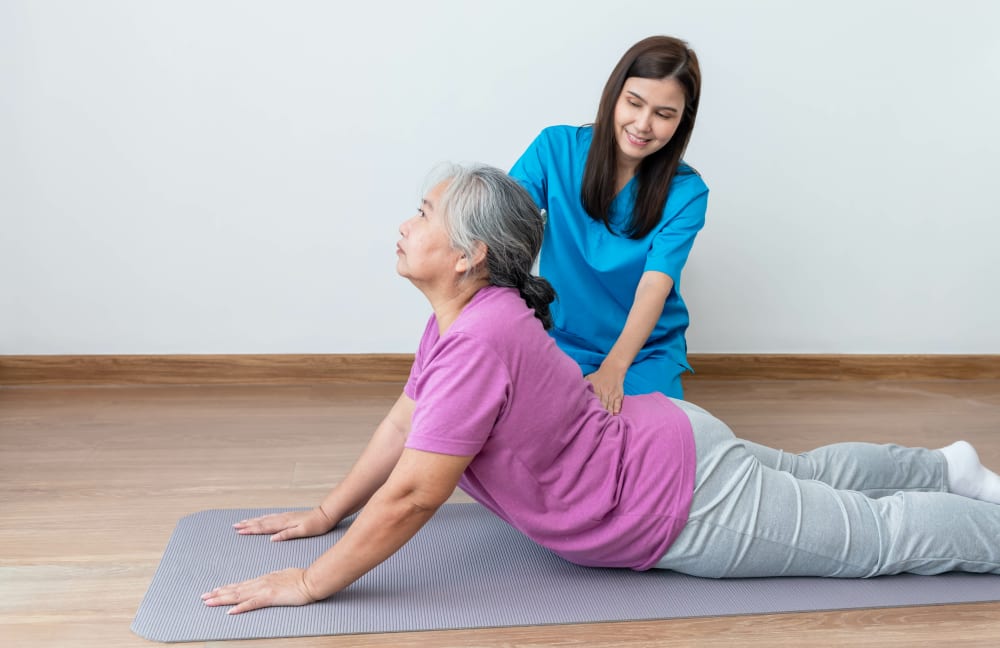 Physical therapist helping patient with back and lumbar physiotherapy